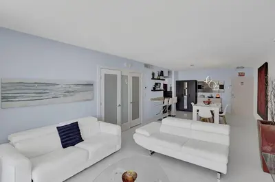 a white living room with two white couches and a table at Beautiful 1 1 Beach View 14 Floor in Hollywood