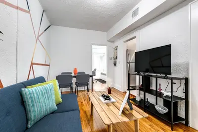 a living room with a blue couch and a table at Pleasing Little Havana Apt Fast WiFi Hv1 in Miami