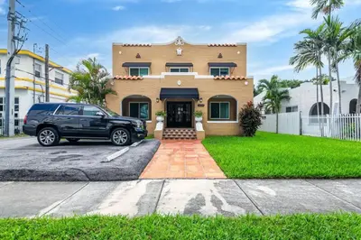 a black car parked in front of a house at Pleasing Little Havana Apt Fast WiFi Hv1 in Miami