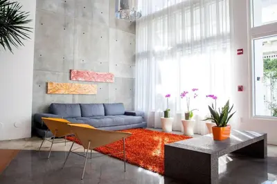 a living room with a blue couch and a red rug at Contemporary Loft in Beautiful Down 4 people 1608 in Miami