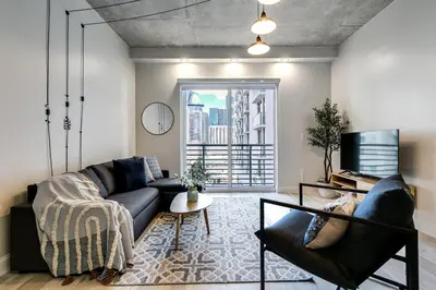 a living room with a couch and a tv at Contemporary Loft in Beautiful Down 4 people 1608 in Miami