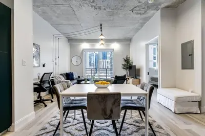 a dining room and living room with a table and chairs at Contemporary Loft in Beautiful Down 4 people 1608 in Miami