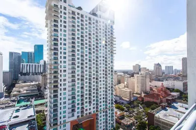 a tall white building in a city with buildings at Contemporary Loft in Beautiful Down 4 people 1608 in Miami