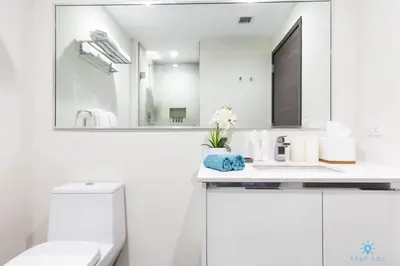 a white bathroom with a sink and a mirror at Cozy Apartment - Hollywood Beach - Amazing Pool in Hollywood