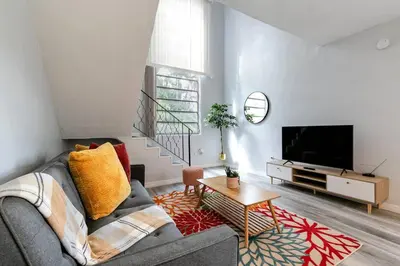 a living room with a couch and a tv at Loft style 1b Apt , Fast Wi-Fi Virg14 in Miami