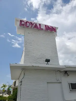 a white building with a sign on top of it at Royal Budget Inn in Miami