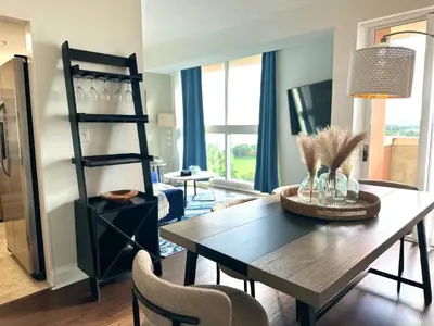 a living room with a dining room table and chairs at Ocean View 2bd2bth Hotel In Coconut Grove in Miami