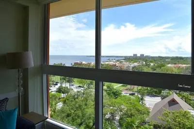 a window in a room with a view of the ocean at Ocean View 2bd2bth Hotel In Coconut Grove in Miami