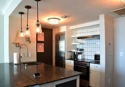 a kitchen with a black counter top in a kitchen at Sight Of Sail Boats! Tranquil 115 Coconut Grove in Miami