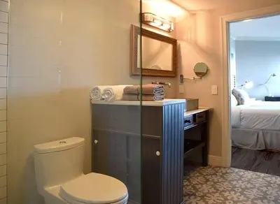 a bathroom with a toilet and a sink and a bed at Sight Of Sail Boats! Tranquil 115 Coconut Grove in Miami