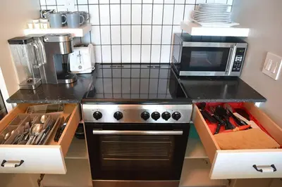 a kitchen with a stove and a microwave at Sight Of Sail Boats! Tranquil 115 Coconut Grove in Miami