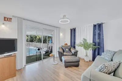 a living room with a couch and a tv at Tranquil Pool Home in Hollywood Close to Beach Airport in Hollywood