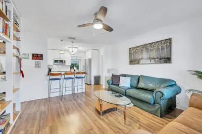 a living room with a couch and a table at Tranquil Pool Home in Hollywood Close to Beach Airport in Hollywood