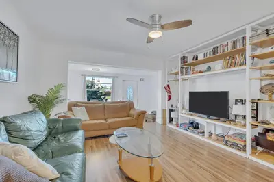 a living room with a couch and a tv at Tranquil Pool Home in Hollywood Close to Beach Airport in Hollywood