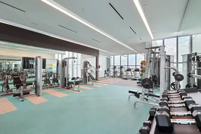 a gym with treadmills and machines in a building at Miami design district, view of the bay - city in Miami