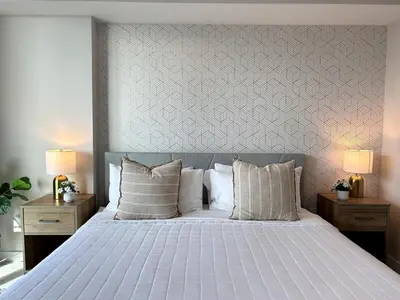 a bedroom with a large white bed with two lamps at Miami design district, view of the bay - city in Miami