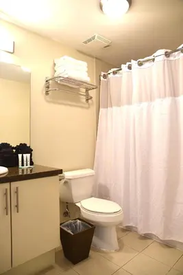 a bathroom with a toilet and a white shower curtain at Amazing Studio - Walking Distance To Cocowalk in Miami