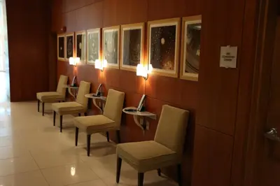 a row of chairs in a waiting room with lights at Stunning 12th Floor Studio In The Heart Of Grove in Miami