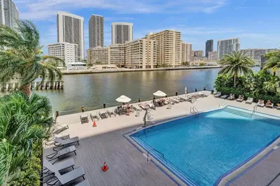 a swimming pool in the middle of a river with buildings at Upscale Resort 4 Bedrooms 3 Bath in Hallandale Beach