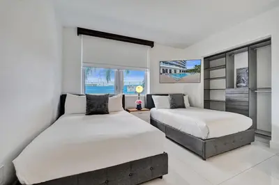 a bedroom with two beds and a window at Upscale Resort 4 Bedrooms 3 Bath in Hallandale Beach