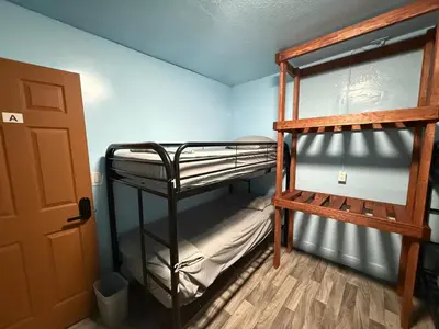 a room with two bunk beds and a door at OQP Vacations in Miami