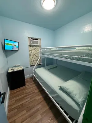 a room with two bunk beds and a television at OQP Vacations in Miami