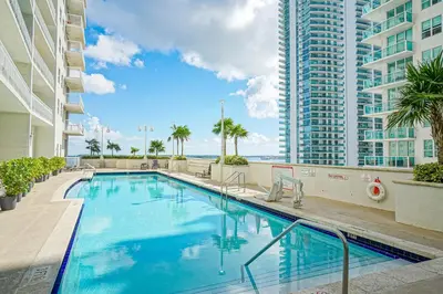 a swimming pool with a view of a building at Zeus' Sanctuary Ocean View In Brickell Miami in Miami