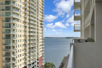 a view of the water between two tall buildings at Zeus' Sanctuary Ocean View In Brickell Miami in Miami