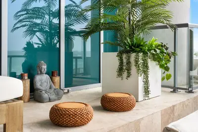 a living room with a statue and two plants at Oceanview Private Townhouse at The Setai 1505-THB in Miami Beach