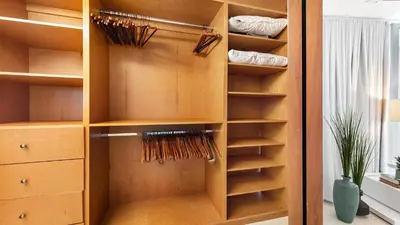a closet filled with wooden shelves and a window at Oceanview Private Townhouse at The Setai 1505-THB in Miami Beach