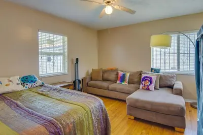 a bedroom with a bed and a couch and a fan at El Portal Vacation Rental about 9 Mi to Miami! in Miami