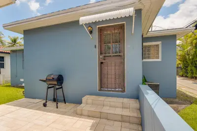 a blue house with a front door and a grill at El Portal Vacation Rental about 9 Mi to Miami! in Miami