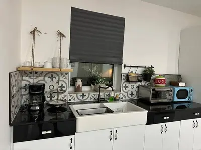 a kitchen with a sink and a microwave at Flora's Garden Apartment/Studio in North Miami