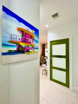 a room with a painting of a boat on the wall at SOBE MONARCH 2 - 2 Bedroom 2 Bathroom Apts - 2 Independent 1 bedrooms apts in Miami Beach