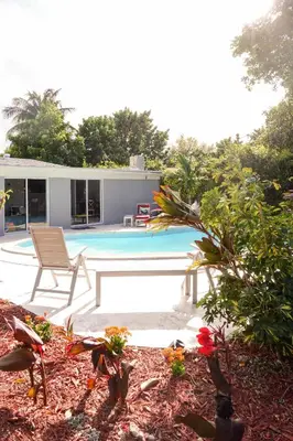 a backyard with a swimming pool and a house at Miami Beach Villa with Sparkling Pool! Sleeps 10+! in North Miami Beach