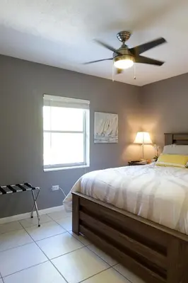 a bedroom with a bed with a ceiling fan at Miami Beach Villa with Sparkling Pool! Sleeps 10+! in North Miami Beach