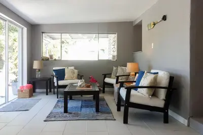 a living room with chairs and a coffee table at Miami Beach Villa with Sparkling Pool! Sleeps 10+! in North Miami Beach