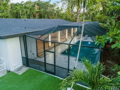 an external view of a house with a swimming pool at VillaKoBo Heated Pool Spa Bar Tennis Golf in Miami