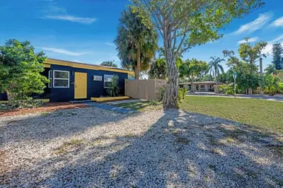 a house with a tree in front of it at New stylish open space: fast Wii-fi and parking in Fort Lauderdale