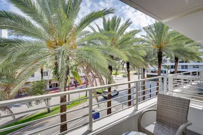 a balcony with a view of palm trees at Miami Beach Vacation Rental with Rooftop Pool Access in Miami Beach