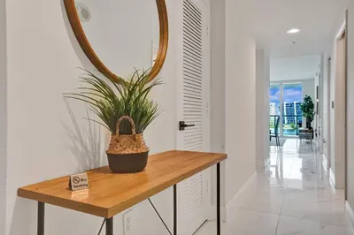 a potted plant sitting on a table in a hallway at Marina Bay Sunny Isles 1005 in Miami Beach
