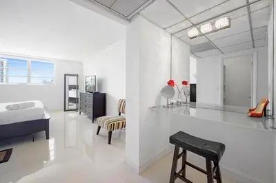 a white bedroom with a bed and a desk at Spacious apartment of 2BR - 2BTH near of the beach great price in Miami Beach