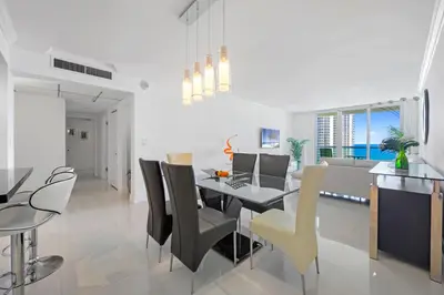 a dining room and living room with a table and chairs at Spacious apartment of 2BR - 2BTH near of the beach great price in Miami Beach