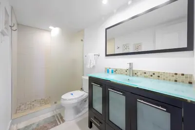 a bathroom with a sink and a toilet and a mirror at Spacious apartment of 2BR - 2BTH near of the beach great price in Miami Beach