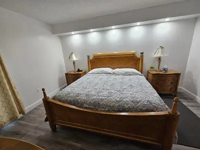a bedroom with a wooden bed and two night stands at 3BR Condo in Sunny Isles Beach in Miami Beach