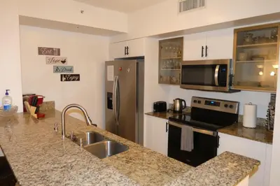 a kitchen with a sink and a stove at 3BR Condo in Sunny Isles Beach in Miami Beach
