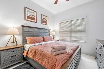 a bedroom with a large bed and a window at VillaLee Luxury Heated Pool & Spa Sauna Golf in North Miami