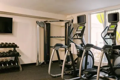 a gym with treadmills and exercise bikes at Kenmore Village Hotel, South Beach in Miami Beach