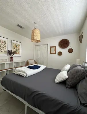 a bedroom with a large bed in a room at Miami's Cozy Tropical Getaway in Miami