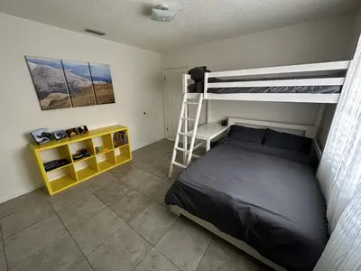 a bedroom with a bunk bed and a ladder at Miami's Cozy Tropical Getaway in Miami